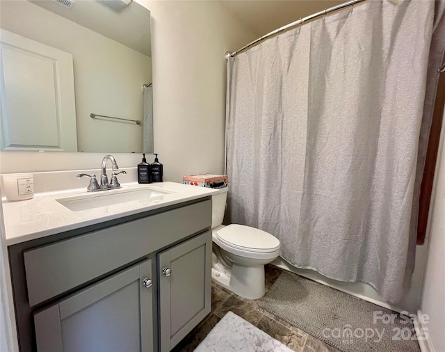 bathroom featuring vanity and toilet