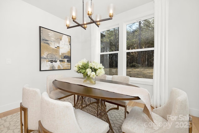 dining room featuring light hardwood / wood-style floors and a notable chandelier