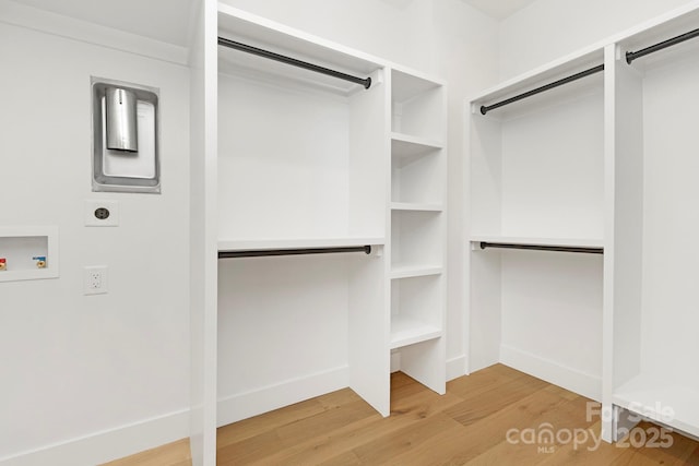 walk in closet with hardwood / wood-style floors