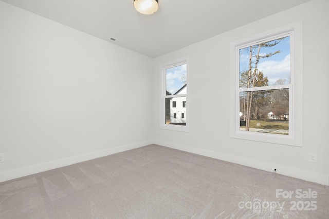 unfurnished room with light colored carpet