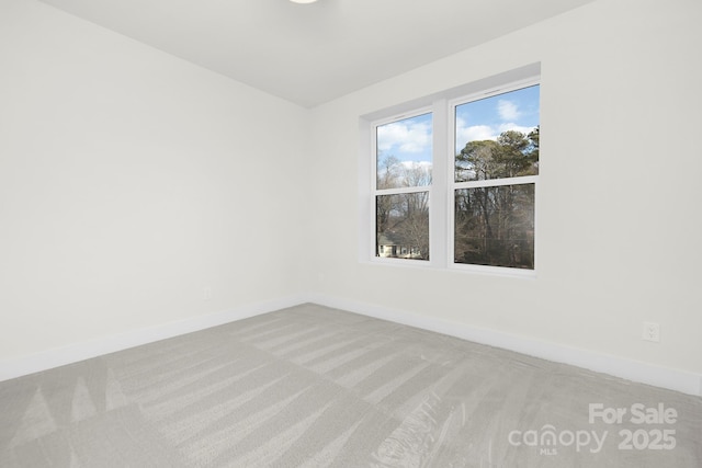 unfurnished room with light colored carpet