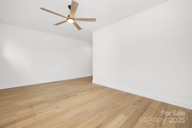 empty room featuring ceiling fan and light wood-type flooring