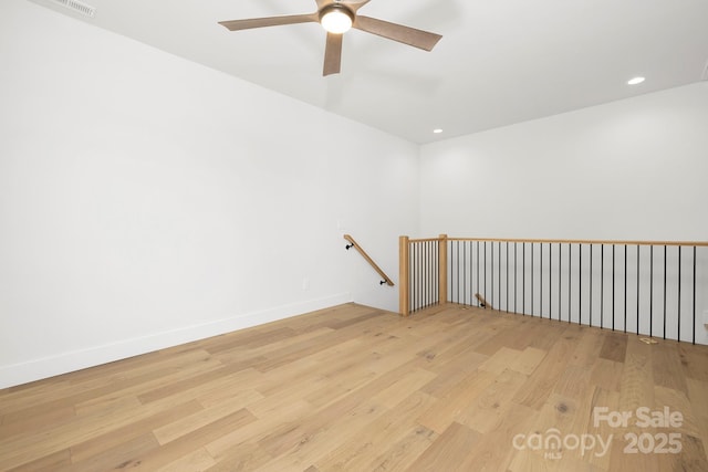 empty room featuring ceiling fan and light hardwood / wood-style floors