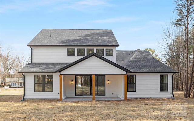 rear view of house featuring a patio area and a lawn