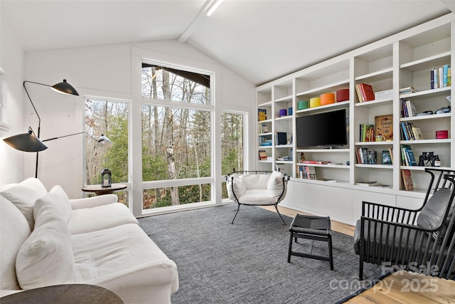 living area with vaulted ceiling with beams