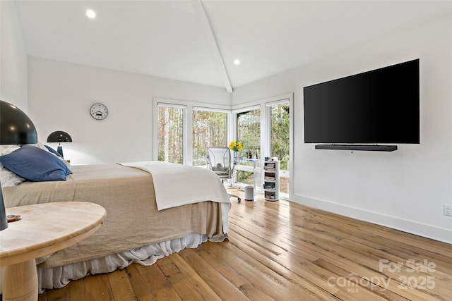 bedroom featuring lofted ceiling with beams and light wood-type flooring