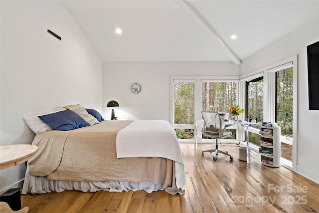 bedroom with hardwood / wood-style flooring and lofted ceiling with beams