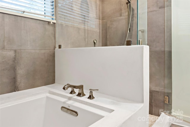 bathroom featuring separate shower and tub and sink