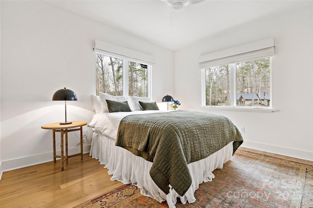 bedroom with hardwood / wood-style floors and ceiling fan