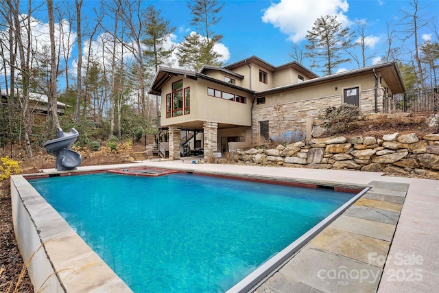 view of pool featuring a patio and a water slide