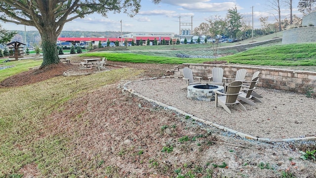 view of yard with an outdoor fire pit