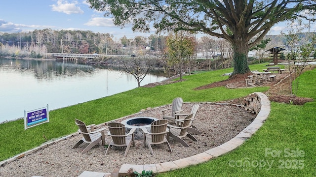 view of yard with a water view and an outdoor fire pit