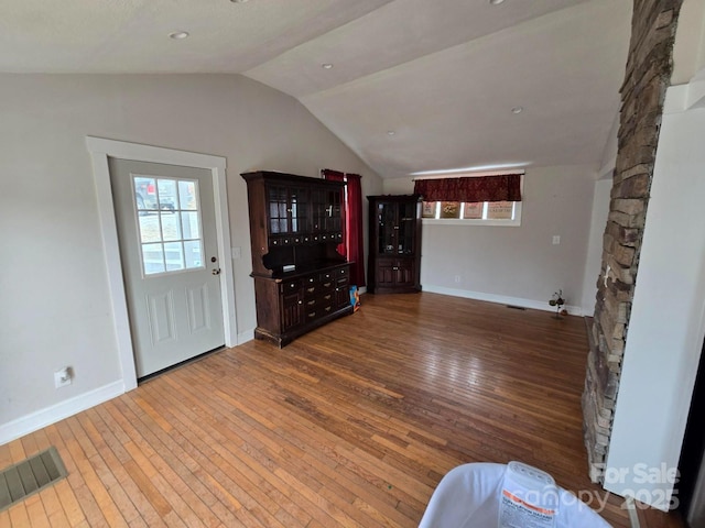 foyer with lofted ceiling and wood-type flooring