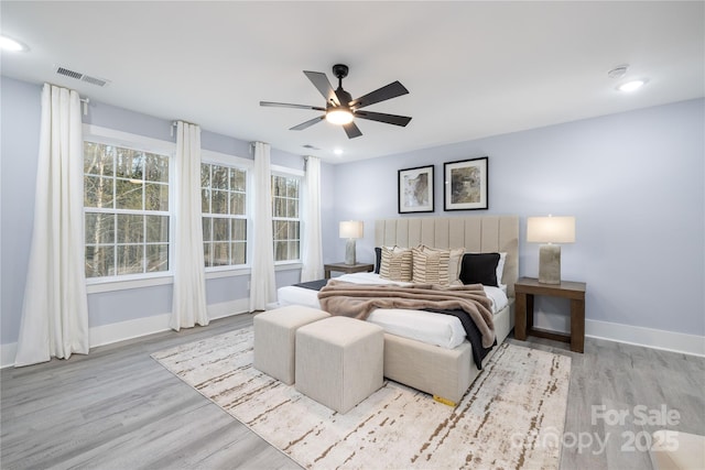 bedroom with ceiling fan and light hardwood / wood-style floors