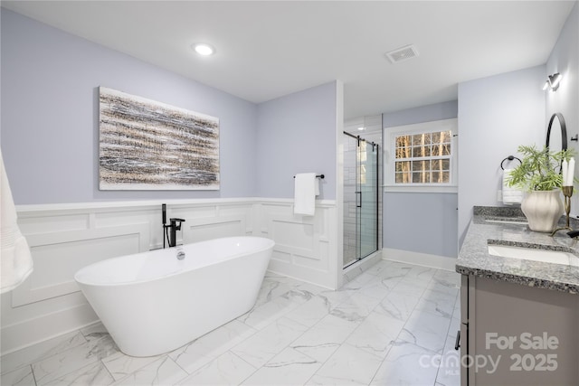 bathroom featuring plus walk in shower and vanity