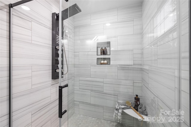 bathroom featuring a shower with shower door