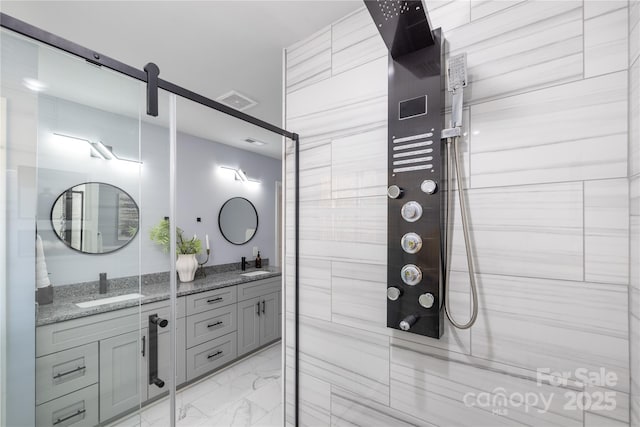 bathroom with vanity and a shower