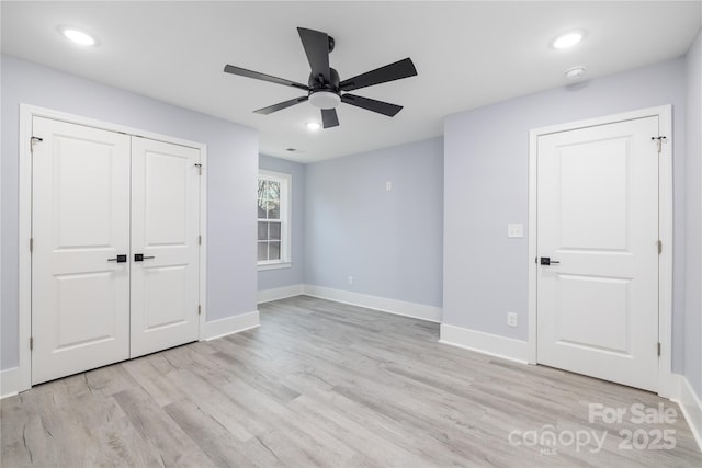 unfurnished bedroom featuring light hardwood / wood-style floors, a closet, and ceiling fan