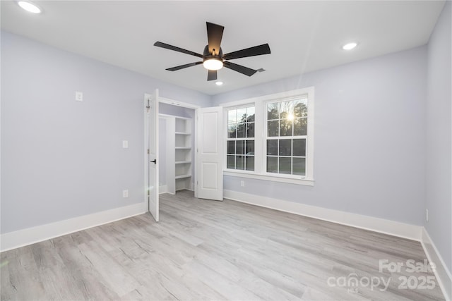 unfurnished bedroom featuring light hardwood / wood-style floors, a closet, and ceiling fan