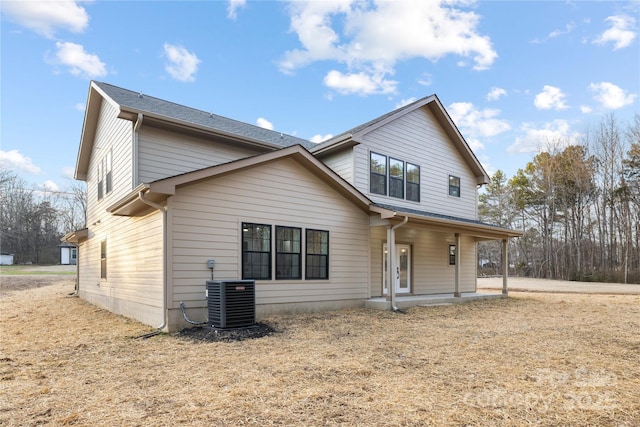 rear view of property with central AC unit