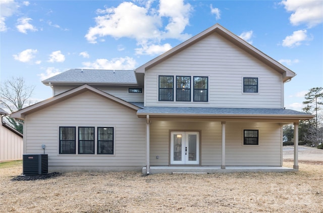 rear view of property with central AC unit and french doors