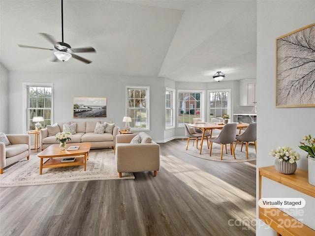 living room featuring ceiling fan, wood-type flooring, and vaulted ceiling