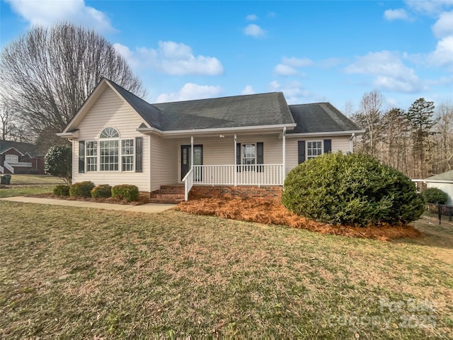 ranch-style home with a front yard and covered porch