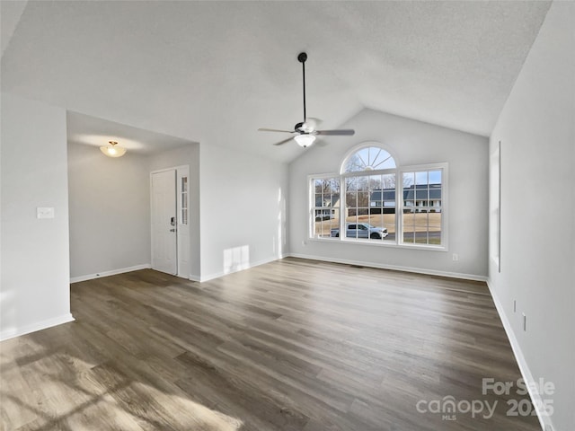 unfurnished living room featuring lofted ceiling, a textured ceiling, dark hardwood / wood-style flooring, and ceiling fan