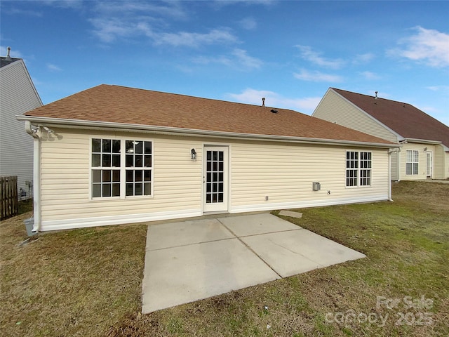 back of house featuring a lawn and a patio area