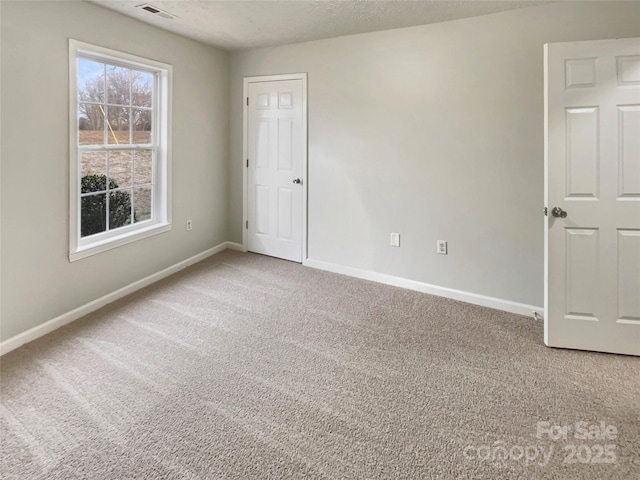 unfurnished room featuring carpet flooring