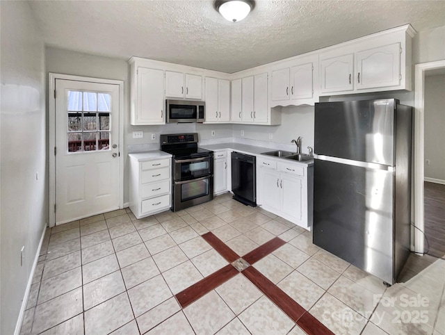 kitchen featuring white cabinetry, sink, stainless steel appliances, and a textured ceiling