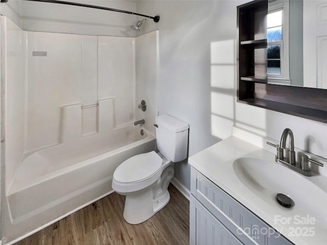 full bathroom with vanity, hardwood / wood-style floors, toilet, and washtub / shower combination