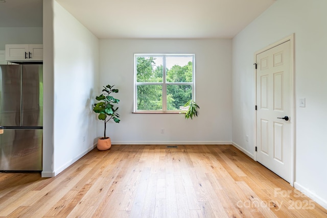 spare room with light hardwood / wood-style flooring