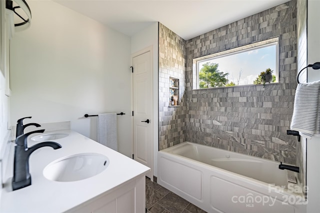 bathroom with vanity and a bath