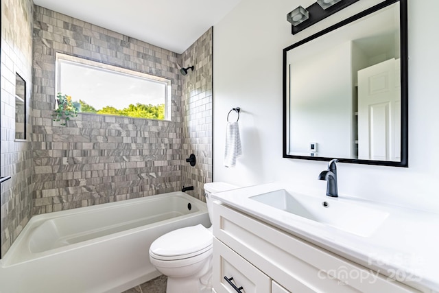 full bathroom featuring vanity, toilet, and tiled shower / bath