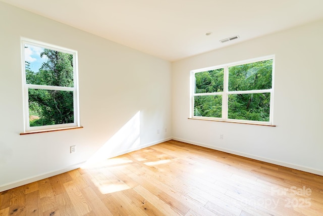 empty room with light hardwood / wood-style flooring