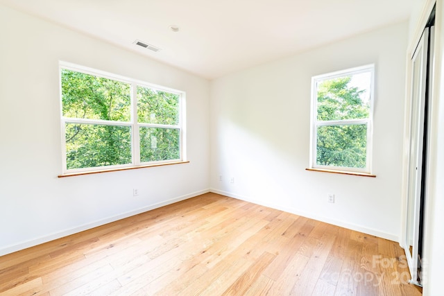 unfurnished room with light hardwood / wood-style flooring