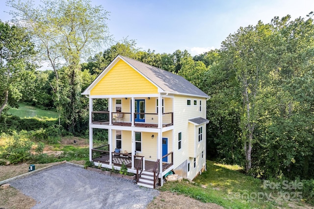 view of front of property with a porch and a balcony