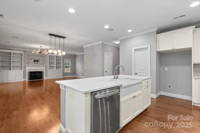 kitchen featuring built in features, white cabinets, dark hardwood / wood-style flooring, a kitchen island with sink, and stainless steel dishwasher