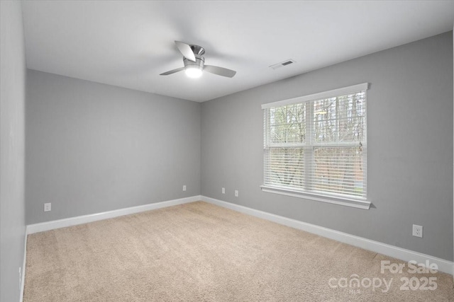 carpeted spare room with ceiling fan