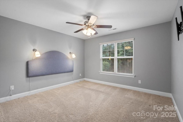 unfurnished room with ceiling fan and carpet flooring