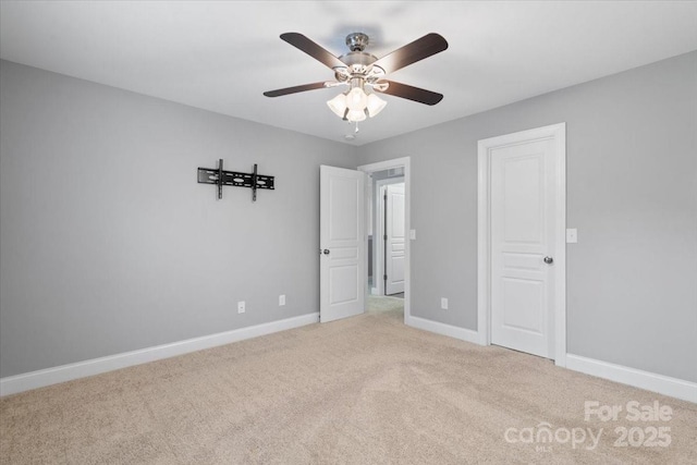 unfurnished bedroom featuring light colored carpet and ceiling fan