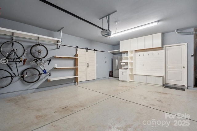 garage with a garage door opener and stainless steel fridge