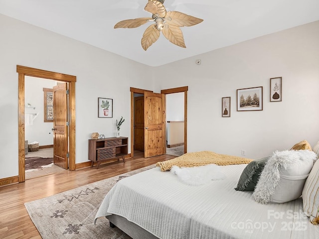 bedroom featuring ceiling fan, baseboards, and wood finished floors