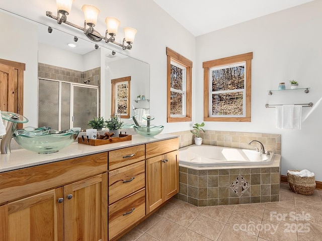 bathroom featuring a garden tub, a stall shower, tile patterned flooring, and vanity