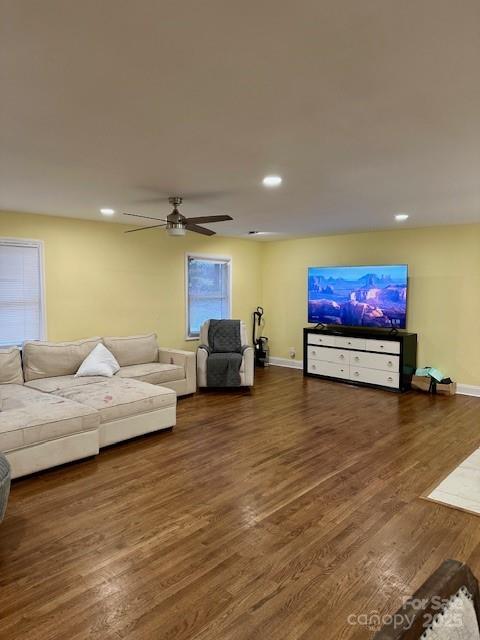 living area with recessed lighting, baseboards, and wood finished floors