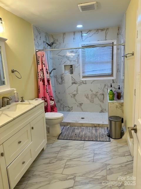 full bath with toilet, visible vents, marble finish floor, and a marble finish shower