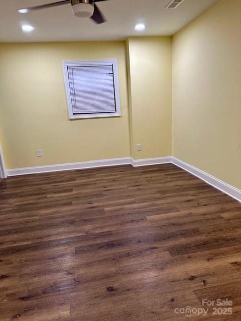 spare room featuring visible vents, baseboards, recessed lighting, dark wood-style floors, and a ceiling fan