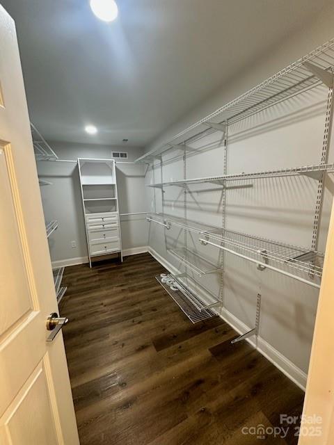 walk in closet featuring wood finished floors and visible vents