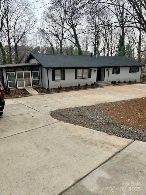 single story home featuring concrete driveway